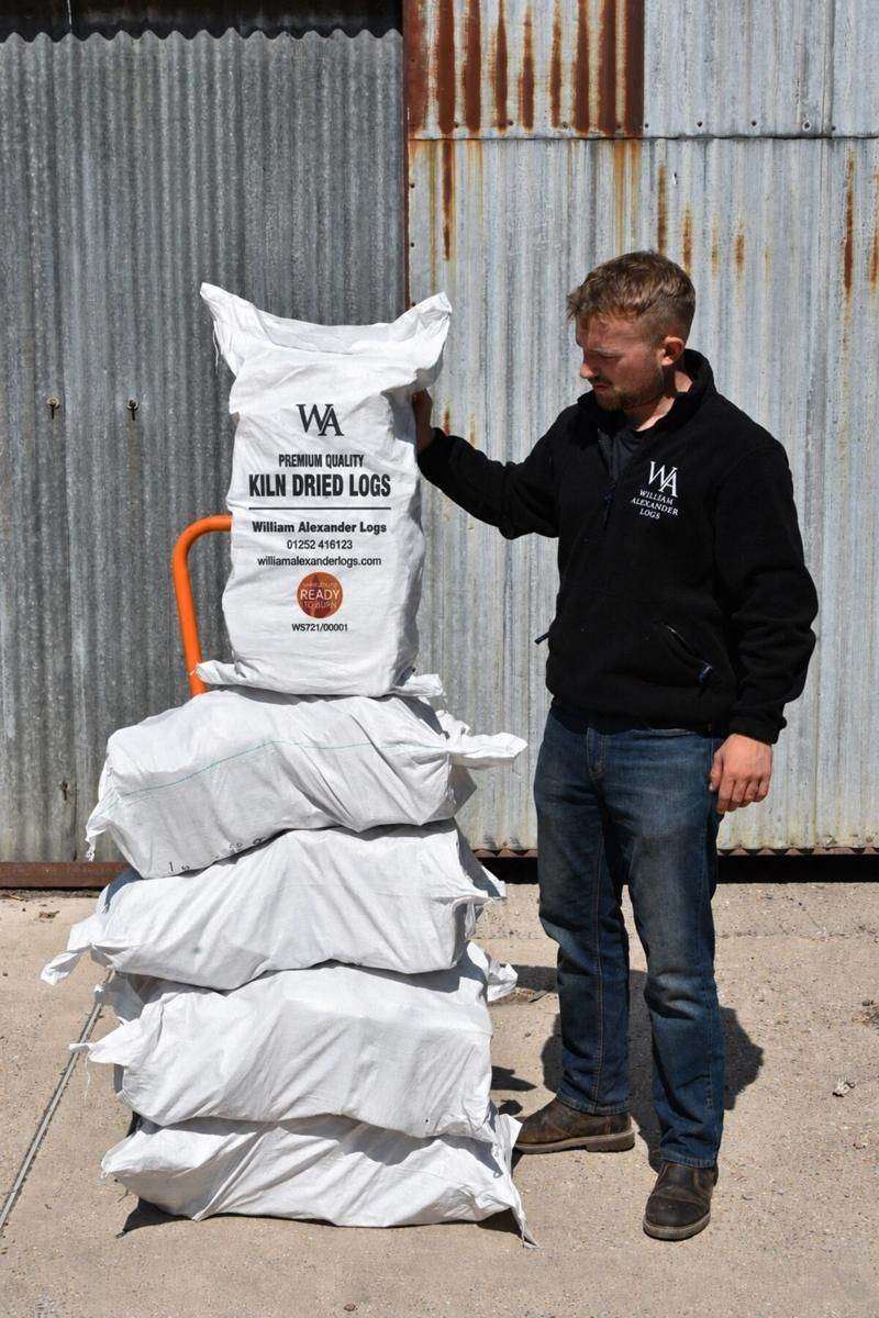 Kiln-dried logs stacked and ready at the William Alexander yard